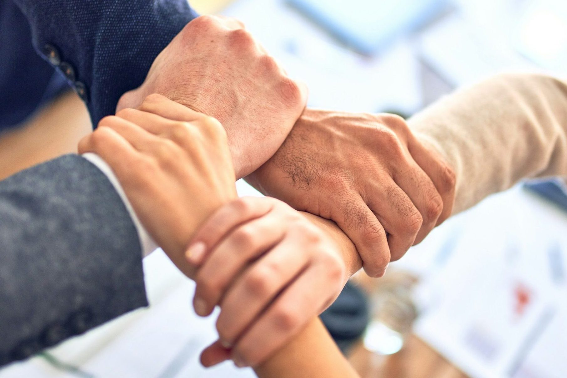 person in black long sleeve shirt holding persons hand